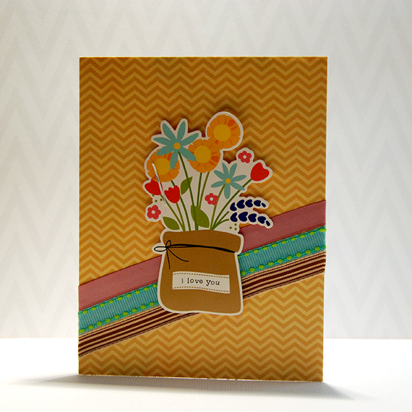 a card with flowers in a vase on it