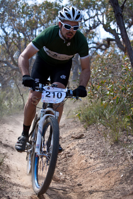 a man riding a bike down a dirt path