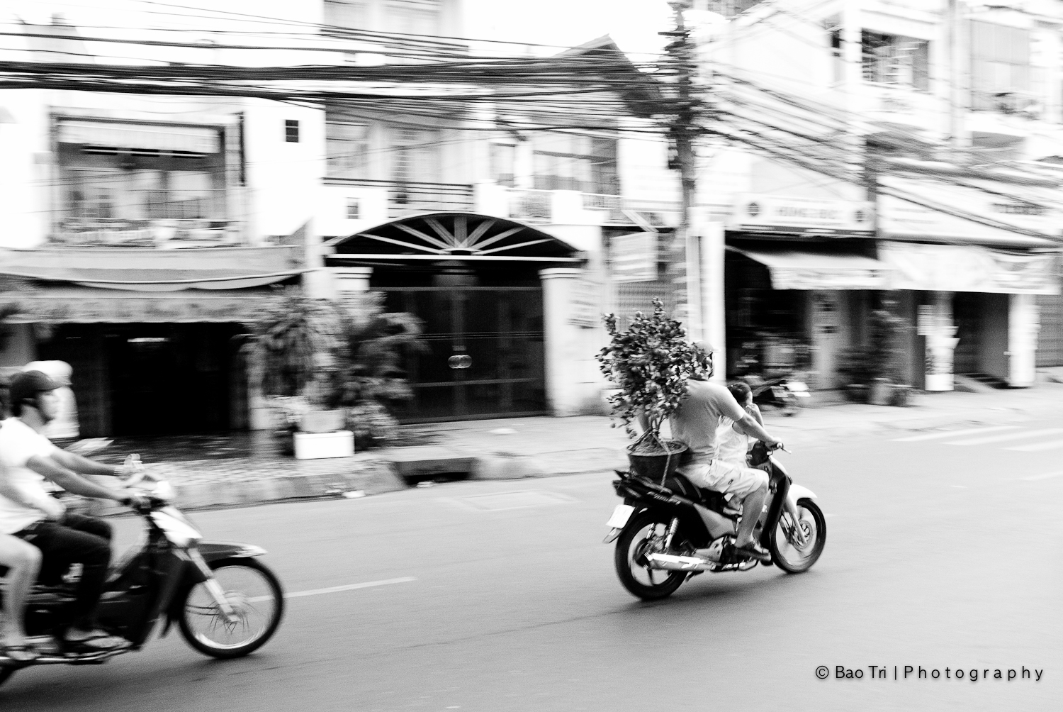 two people are riding motorcycles down the street