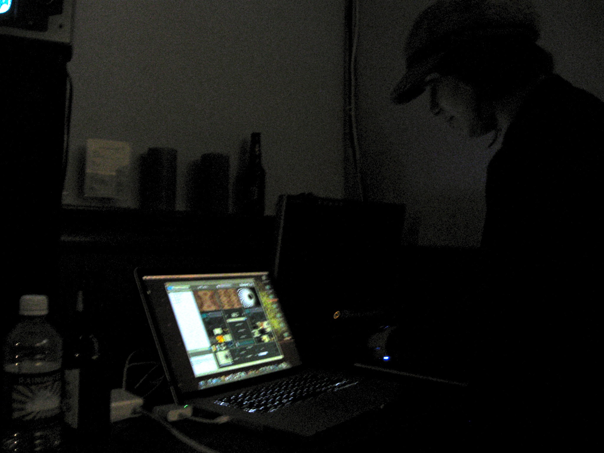 a laptop is lit up on a desk in the dark