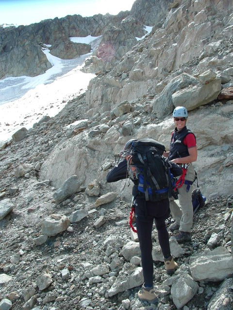 two people on rocks walking towards the camera