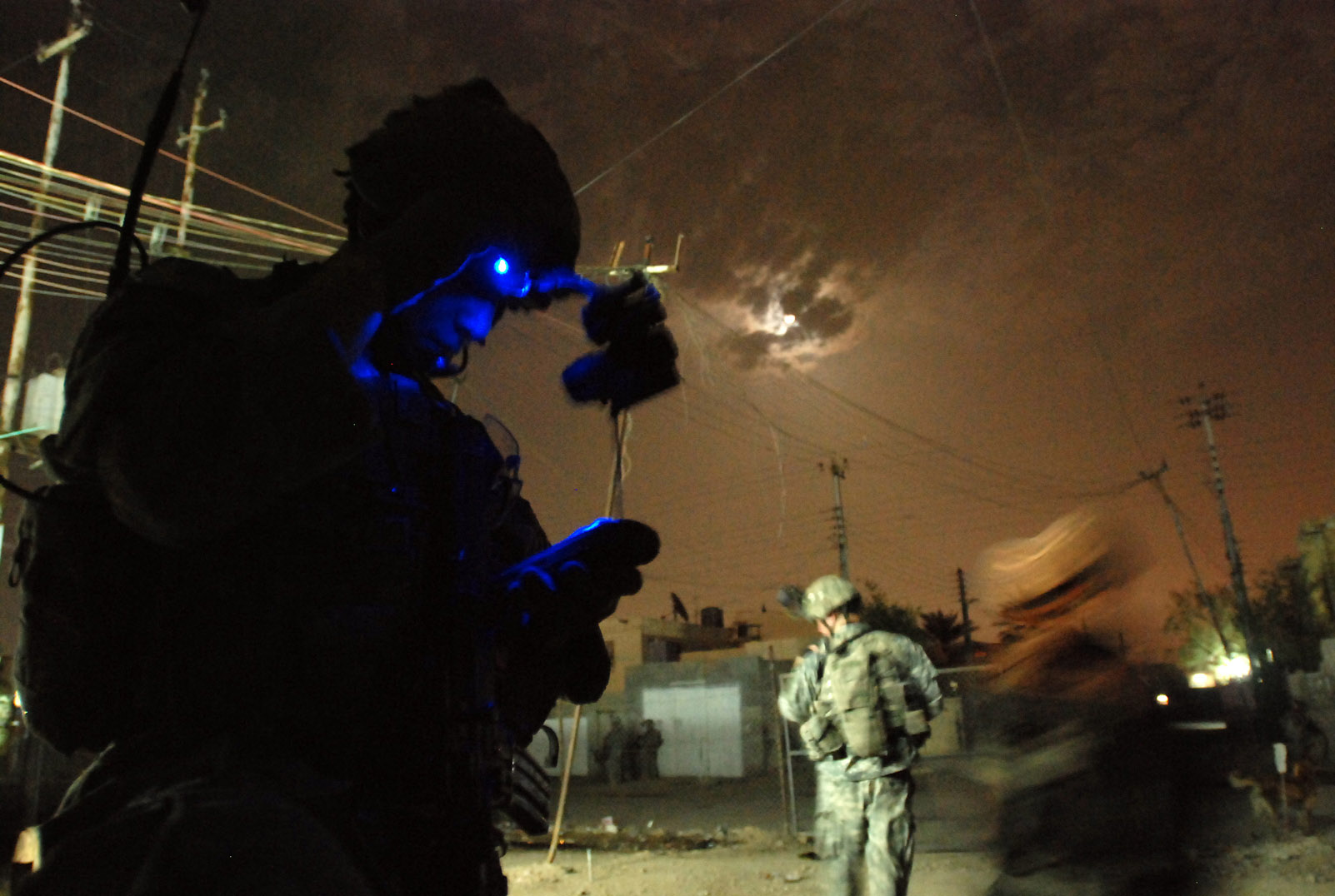 a man wearing futuristic technology looking at his cellphone