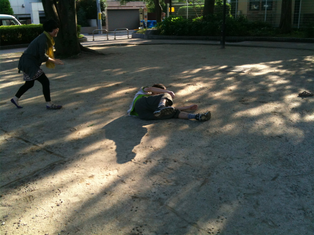 a man is lying down in the street next to another person