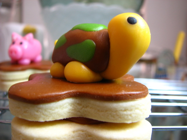 a close up of a pastry and two small toy animals