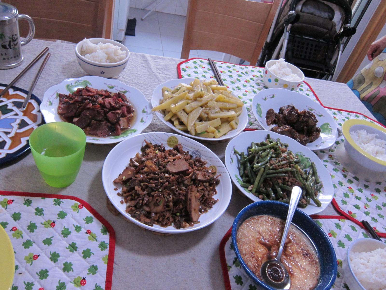 a table filled with different dishes and containers of food