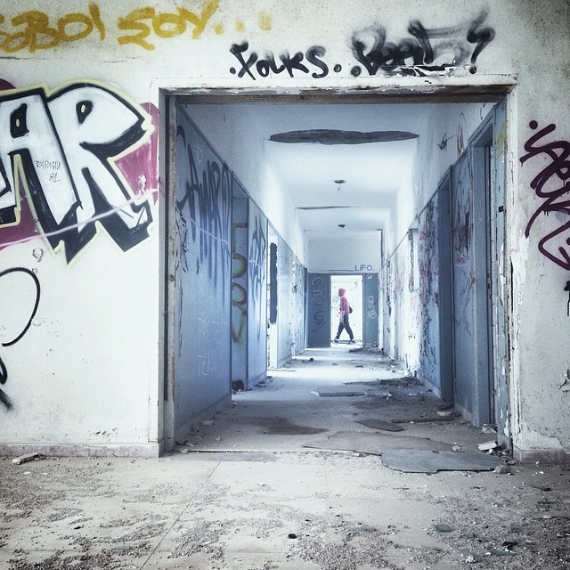 a long hallway with graffiti on it