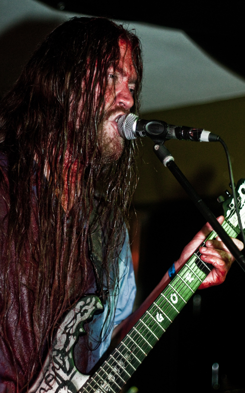 a man with long dread locks playing guitar