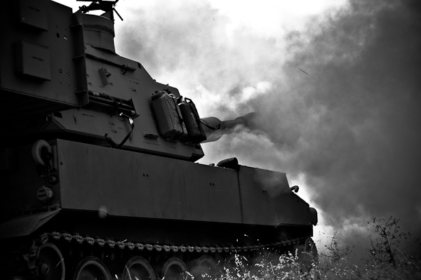 a tank moves through the air on a cloudy day