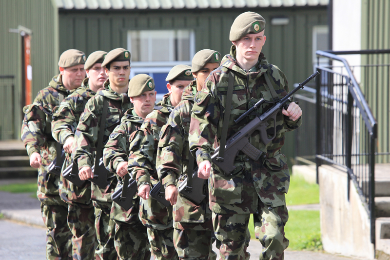 some men in military fatigues are standing next to each other