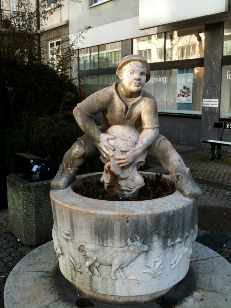 a statue of a person on top of a pot