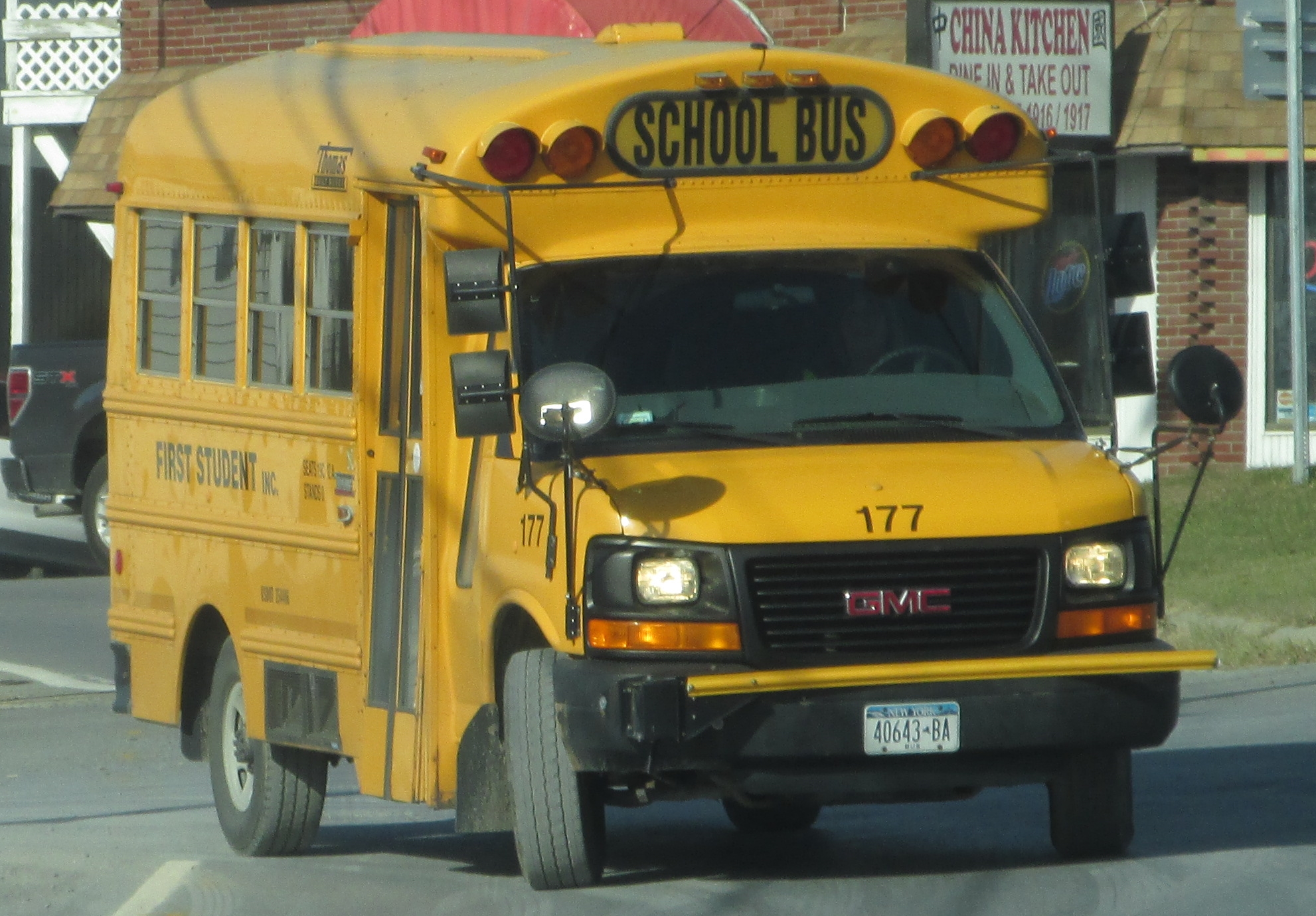 a yellow school bus driving down a street