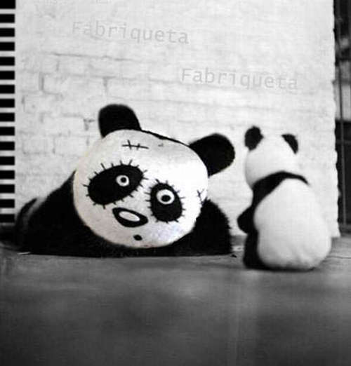 a small stuffed panda bear near a building