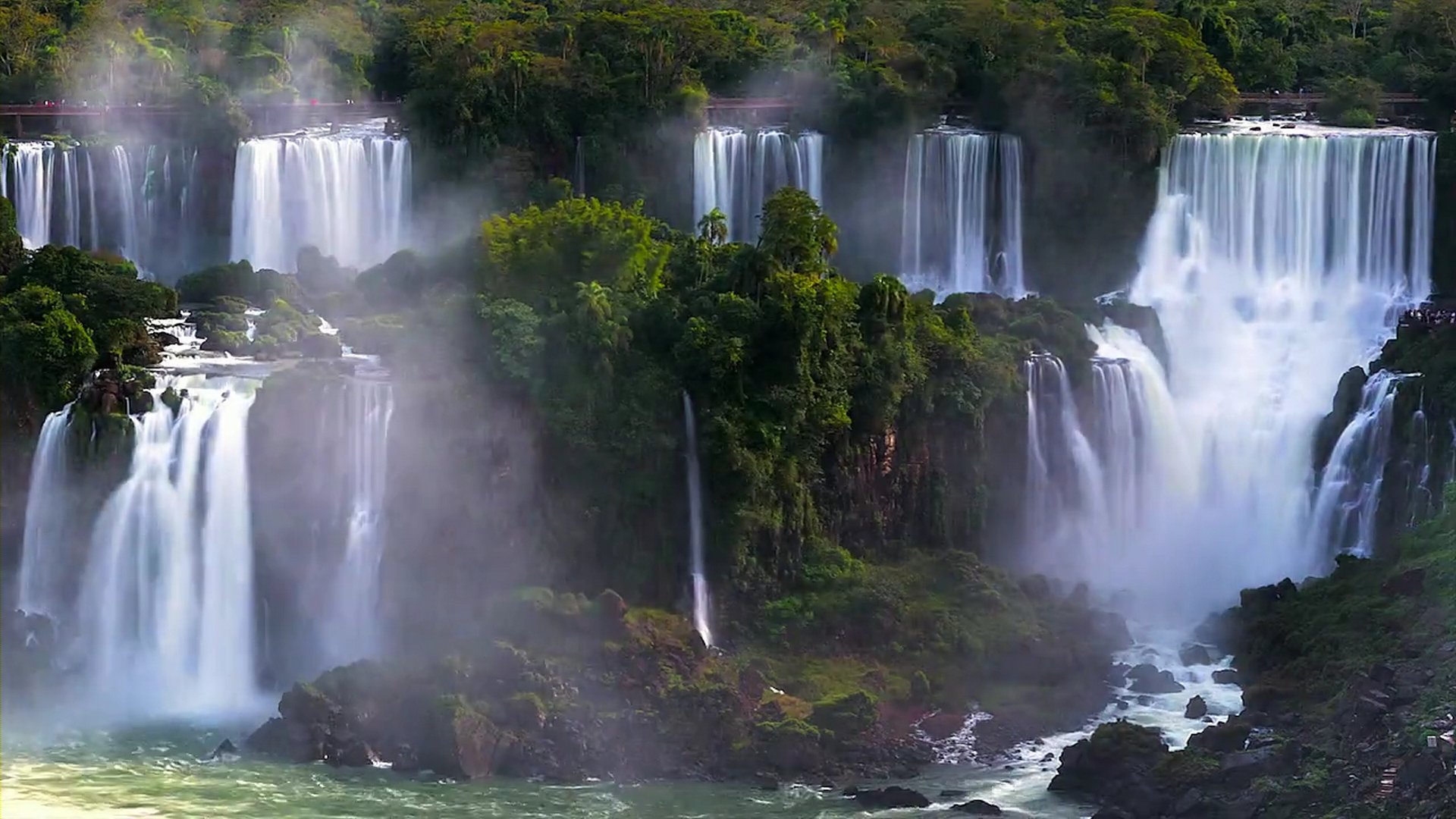 waterfalls are pouring over a large body of water