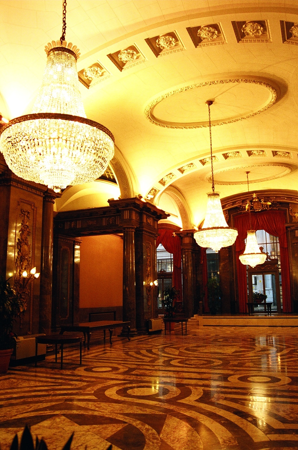 the inside of an elegant building with chandeliers and decor