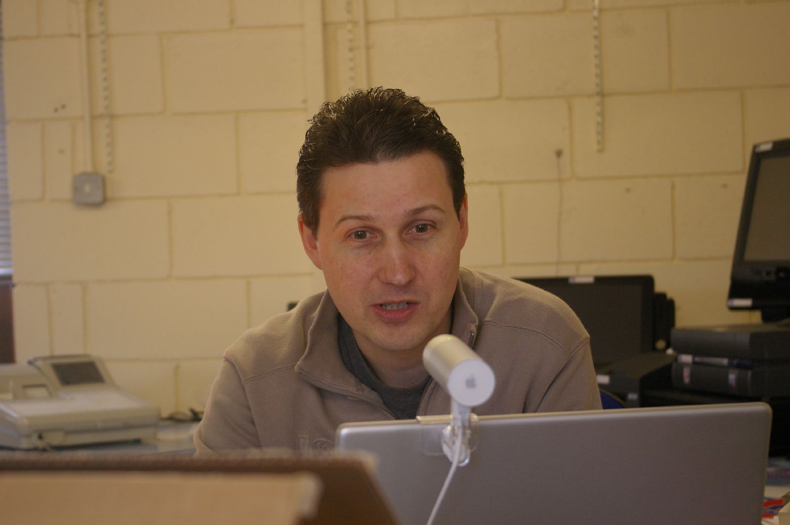 a man making a face while looking at a laptop