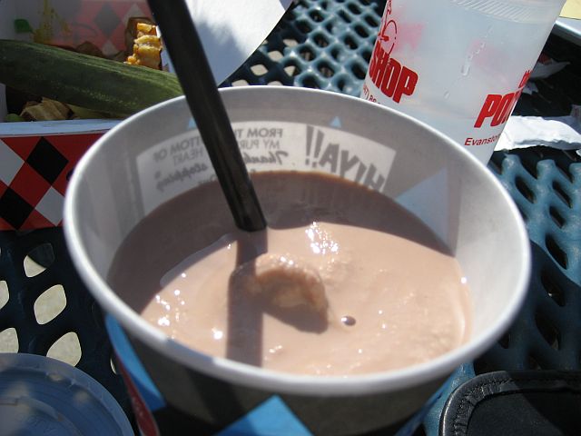 a drink is served with a spoon