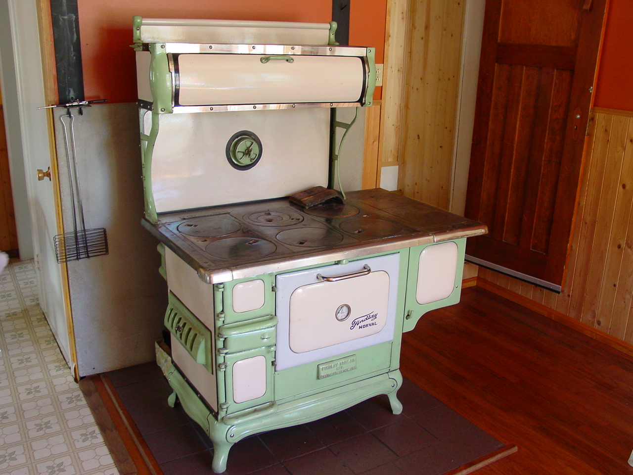 a green and white stove is in a room