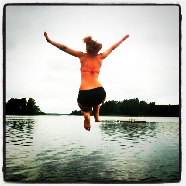 a person jumping off the dock into water