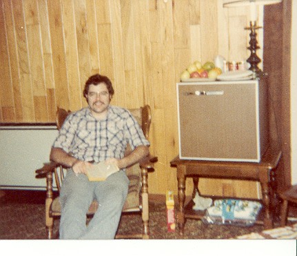 a man sitting on a rocking chair in a living room