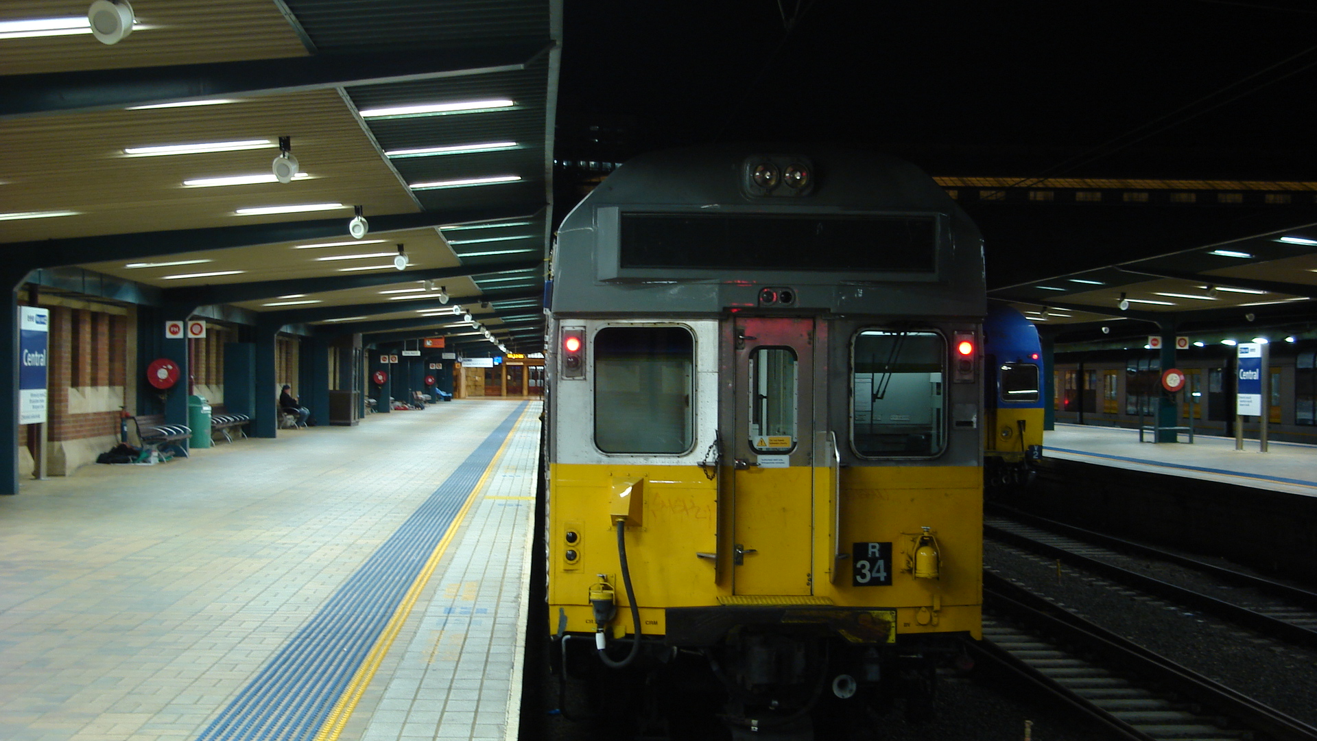 a train parked in a train station with people waiting