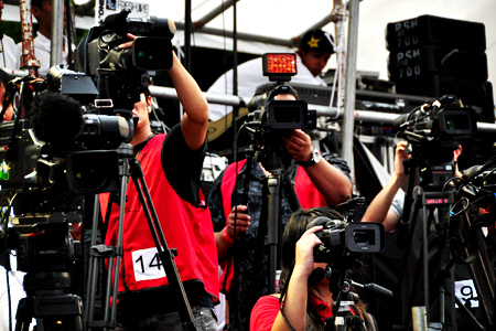 there is an image of two cameramen that are filming