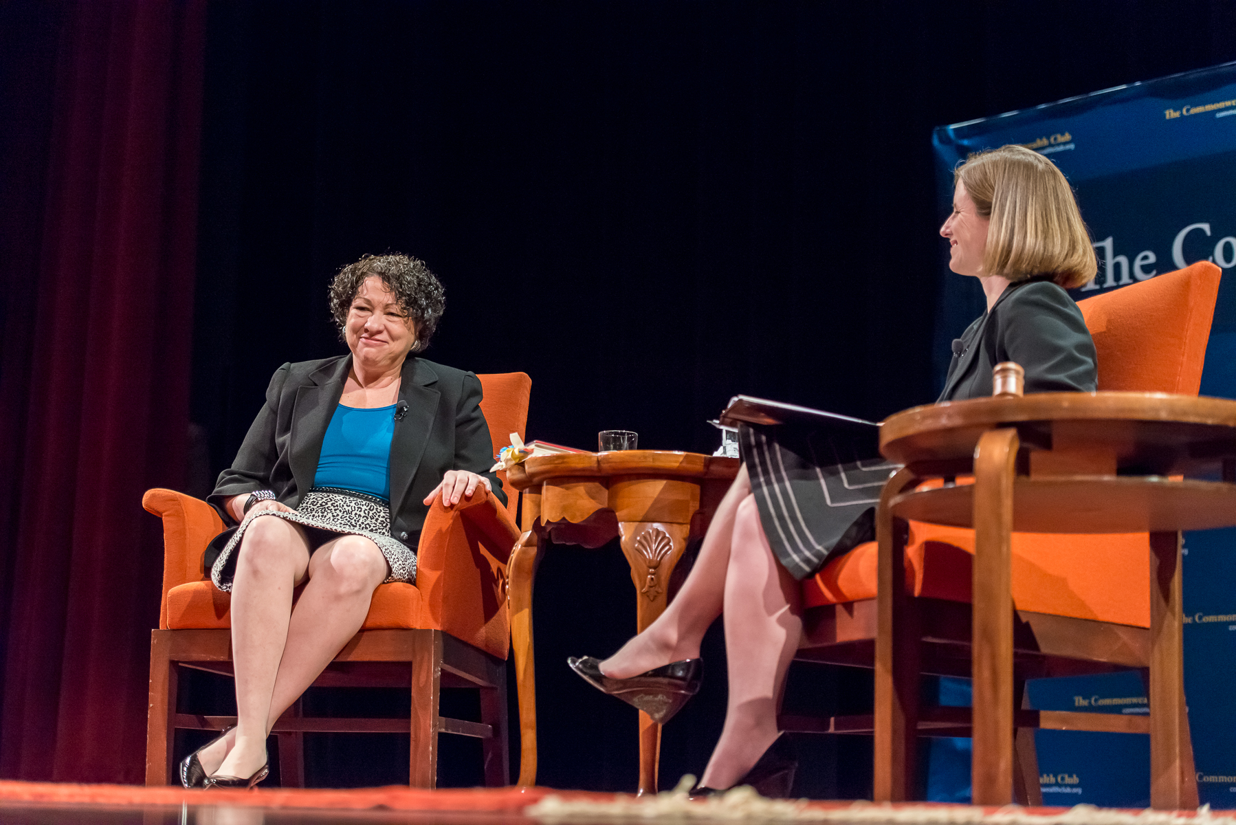 two people talking on chairs and two people seated on the seats