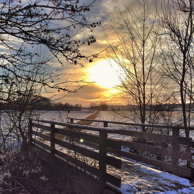 a fence that has snow on the ground