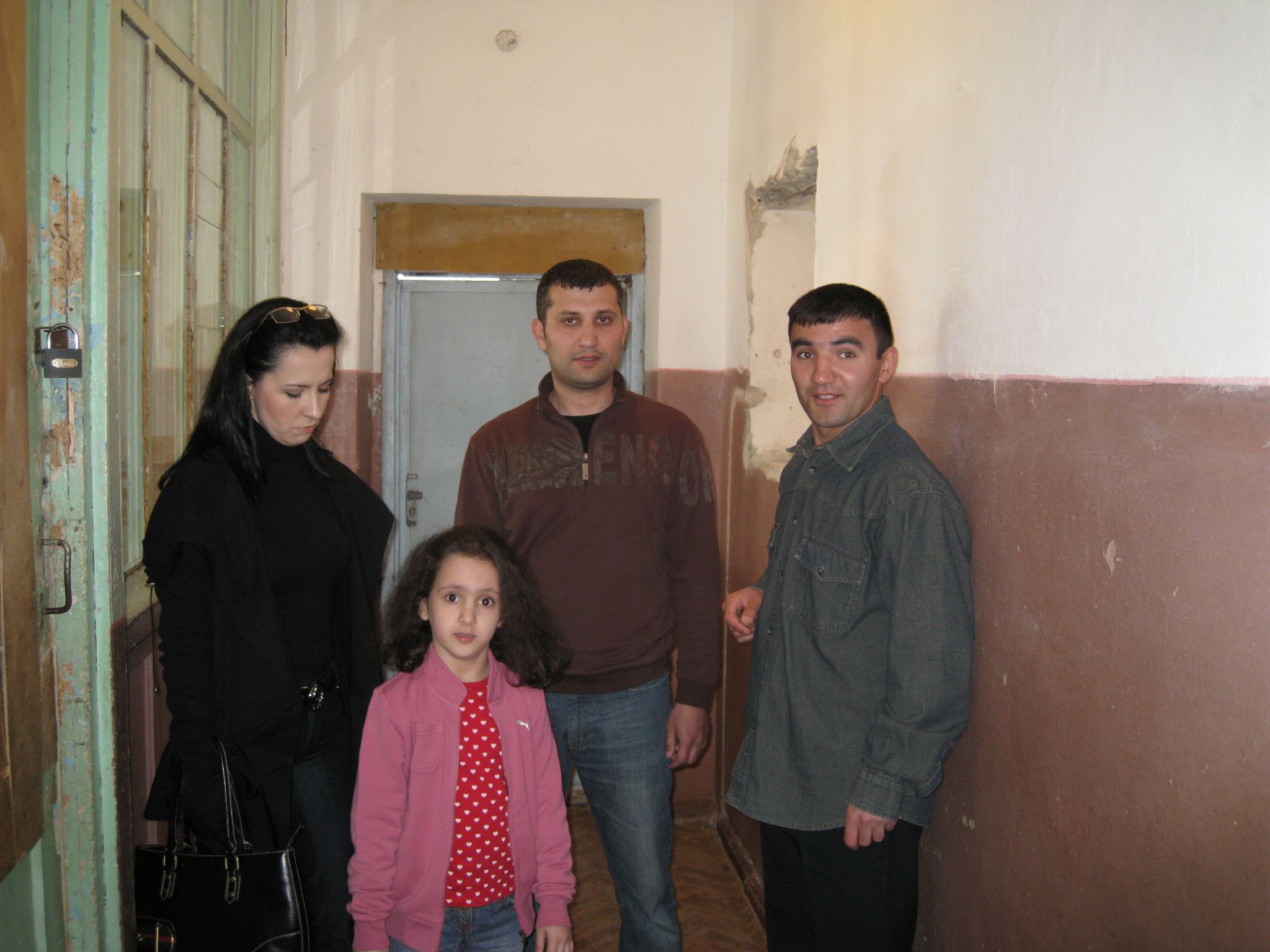 two adults and a child are in a hallway