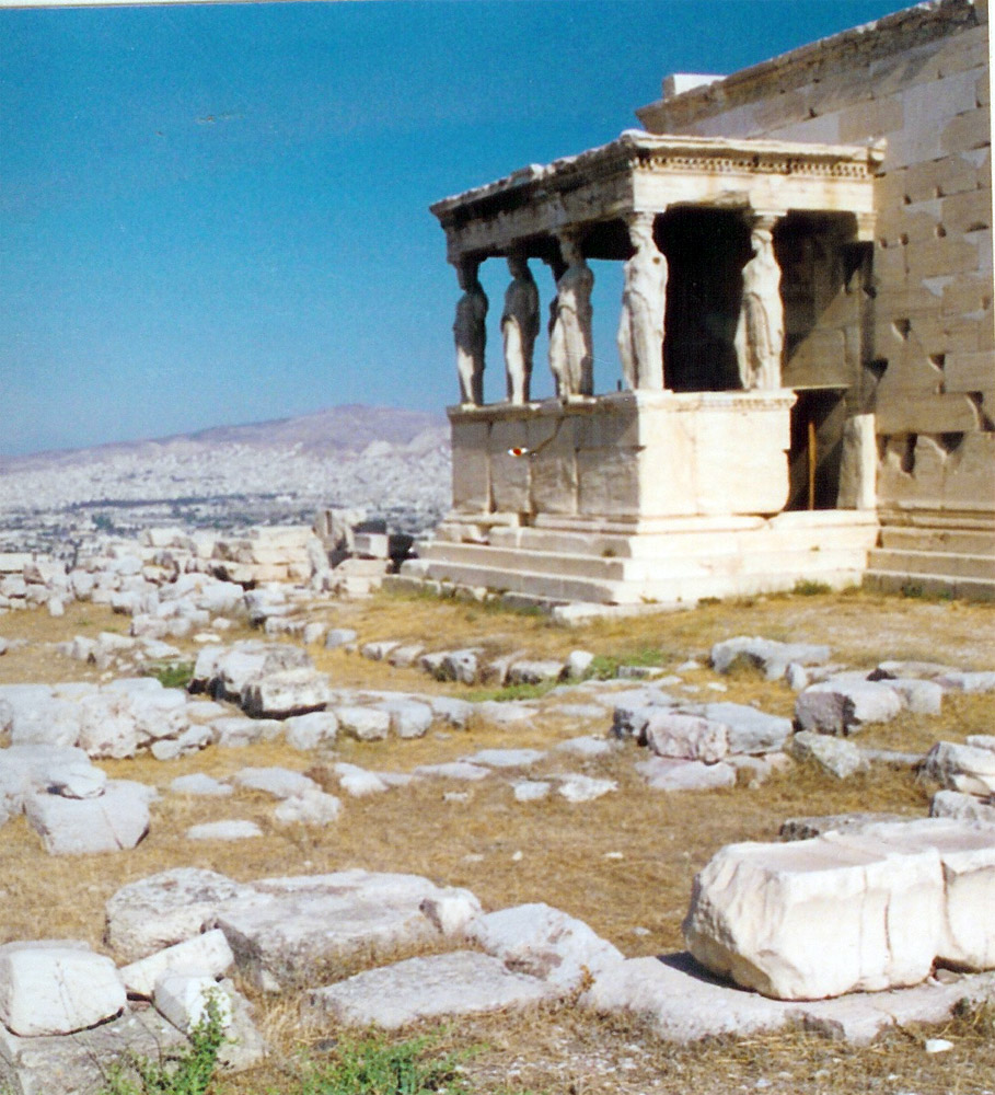 statues of people and ruins in the ancient city