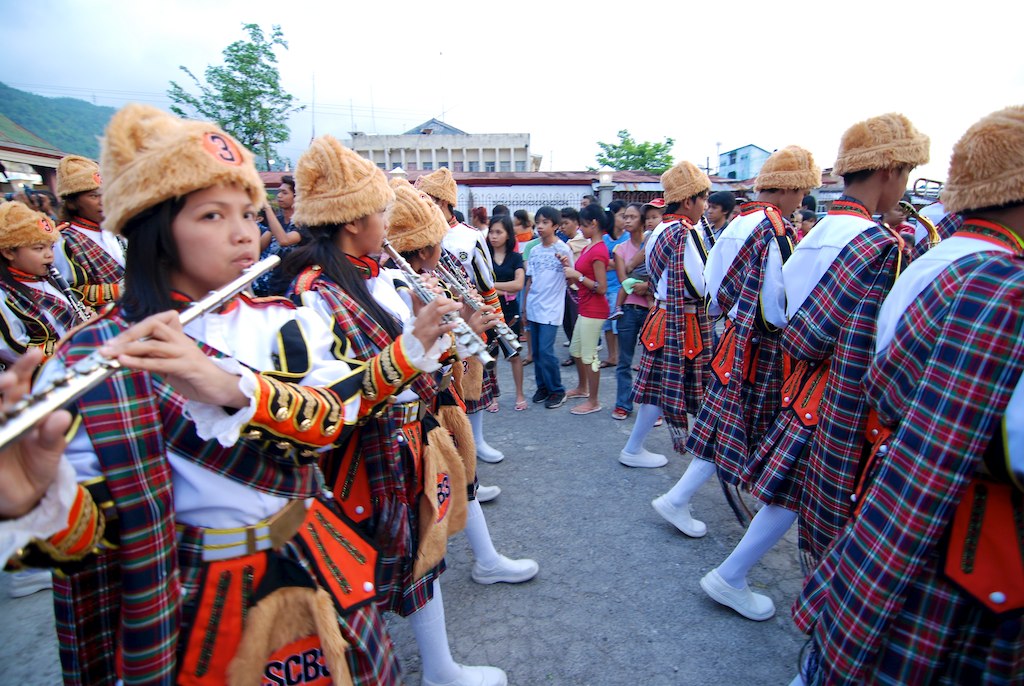 asian people in colorful outfits playing flutes