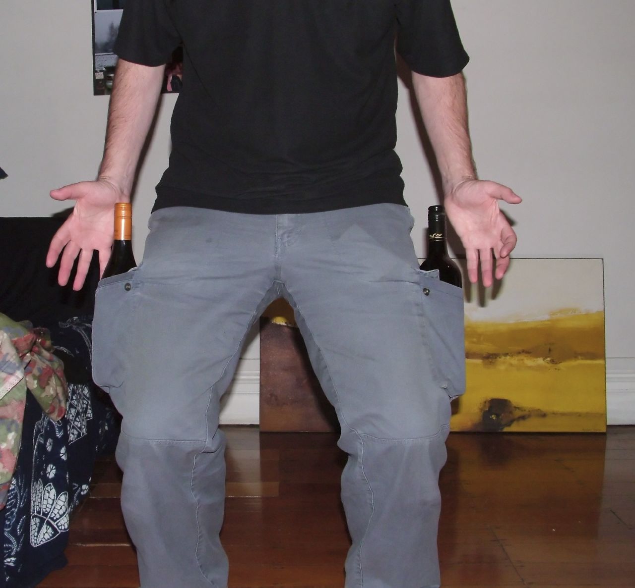 a man in black shirt playing wii with one foot on the ground