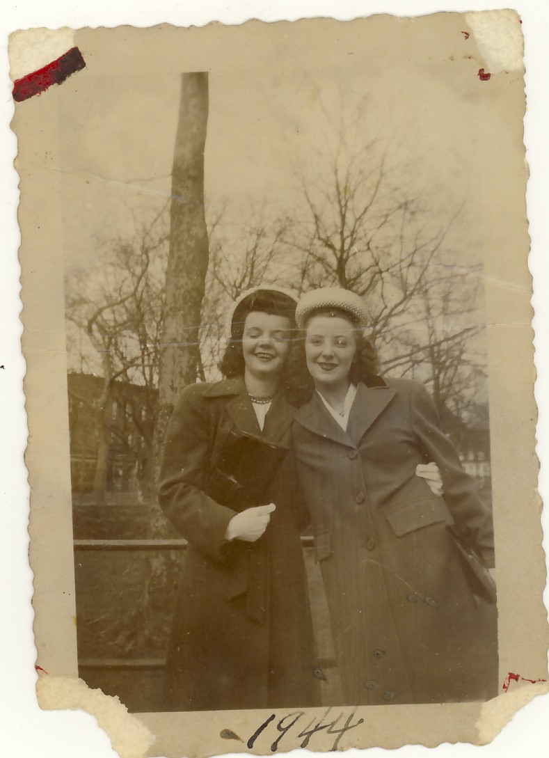 an old picture of two women outside smiling