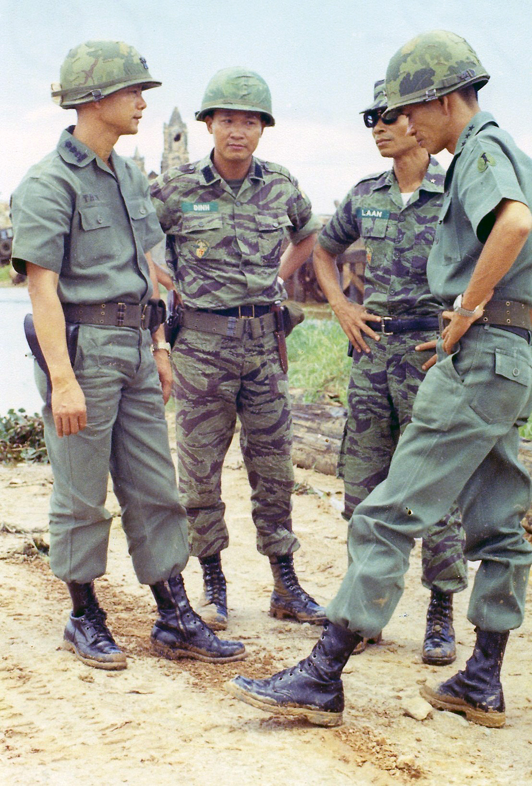 three army officers standing together in uniform