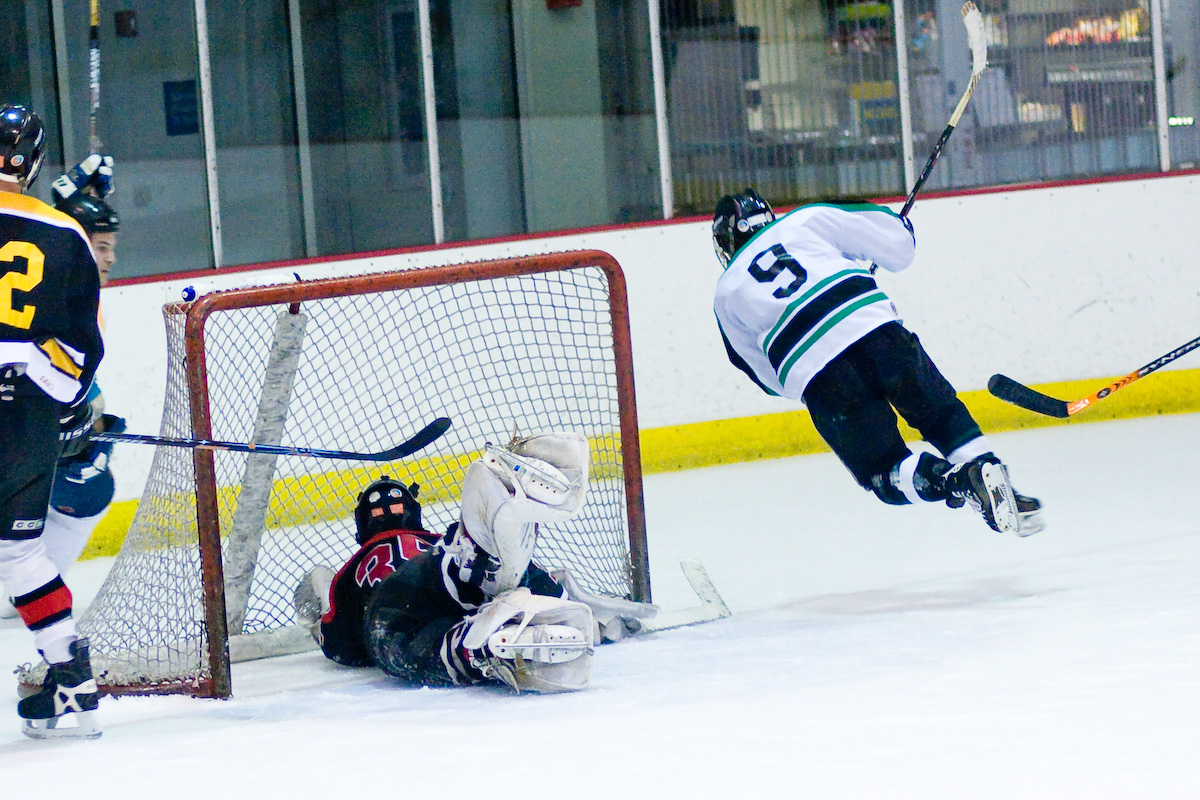 two teams play a hockey match in the ice