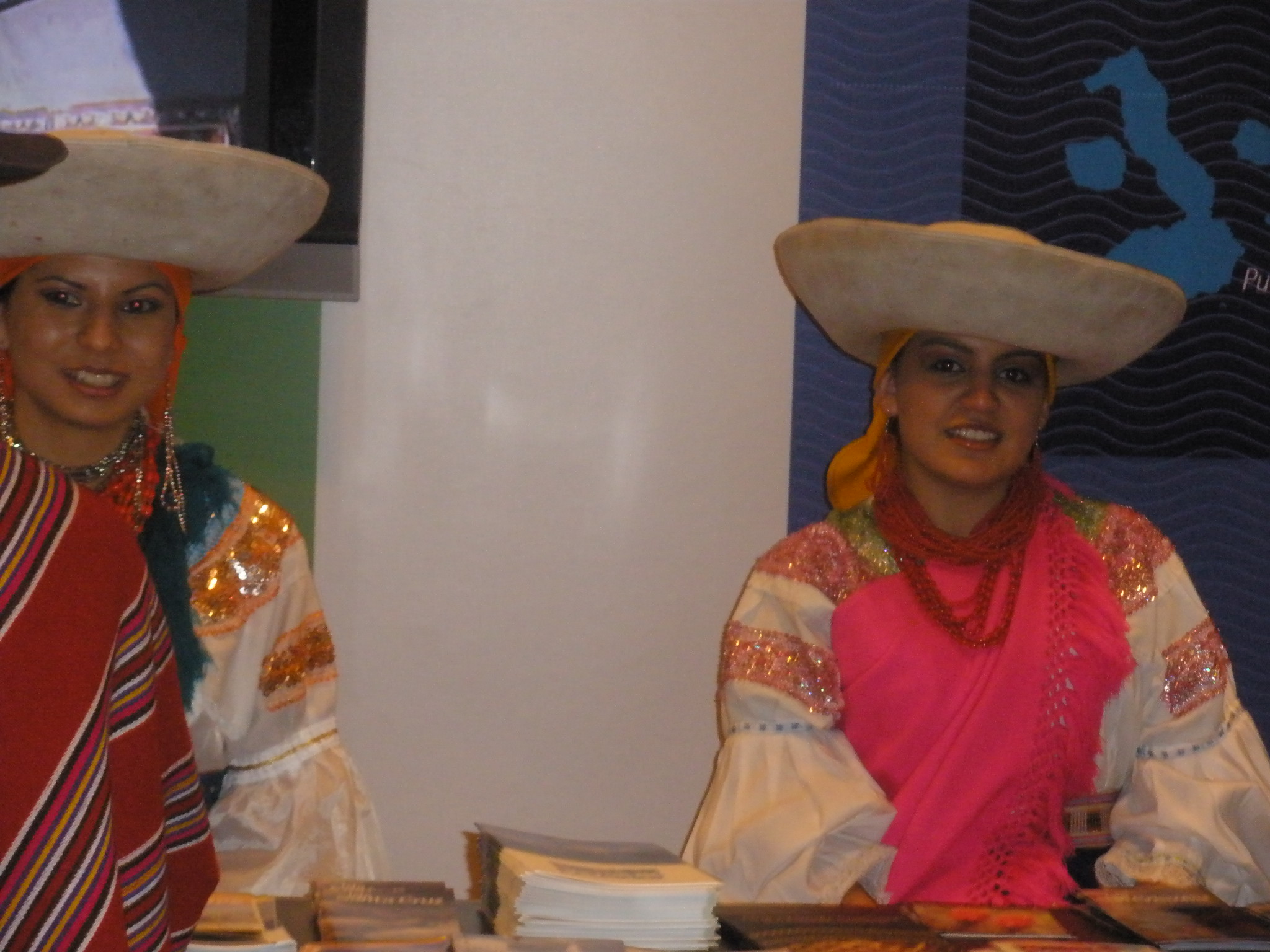 two women in large hats sitting at a table