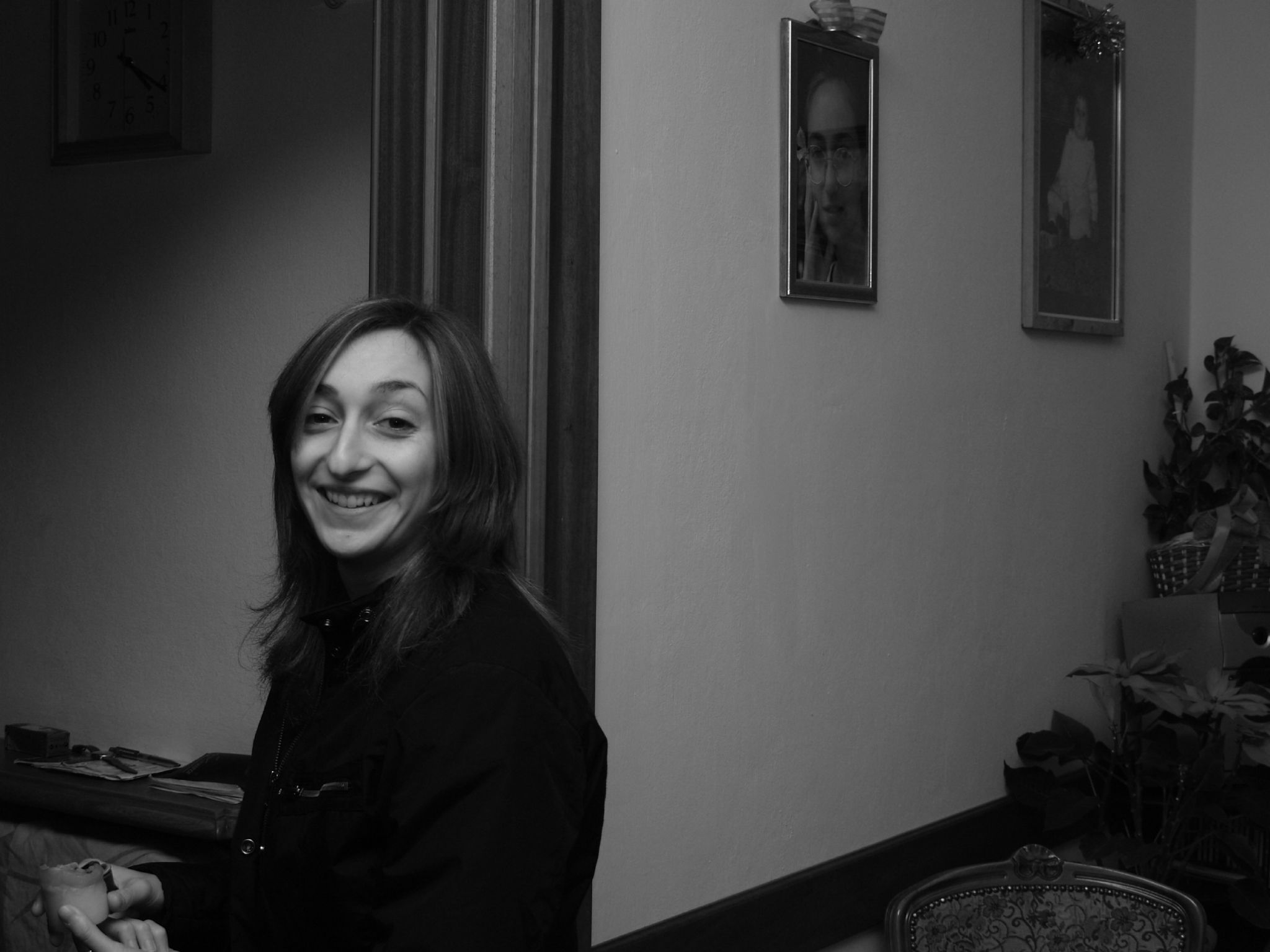 a woman sitting at a piano with her long dark hair