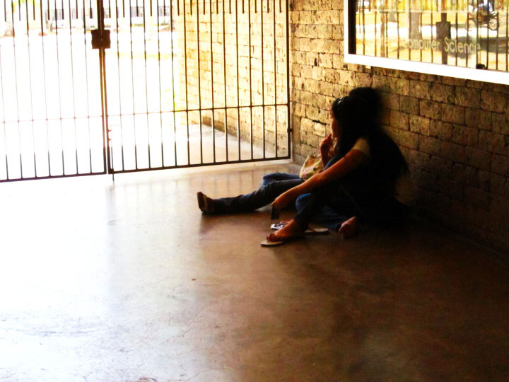 two girls are sitting on the floor next to the wall