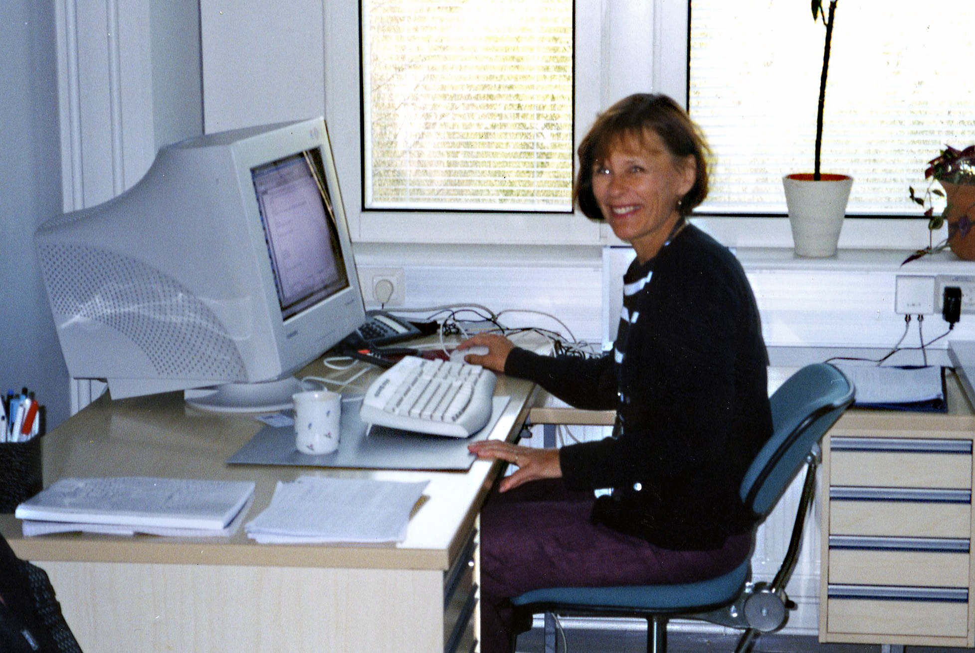 a person sitting at a desk with a computer