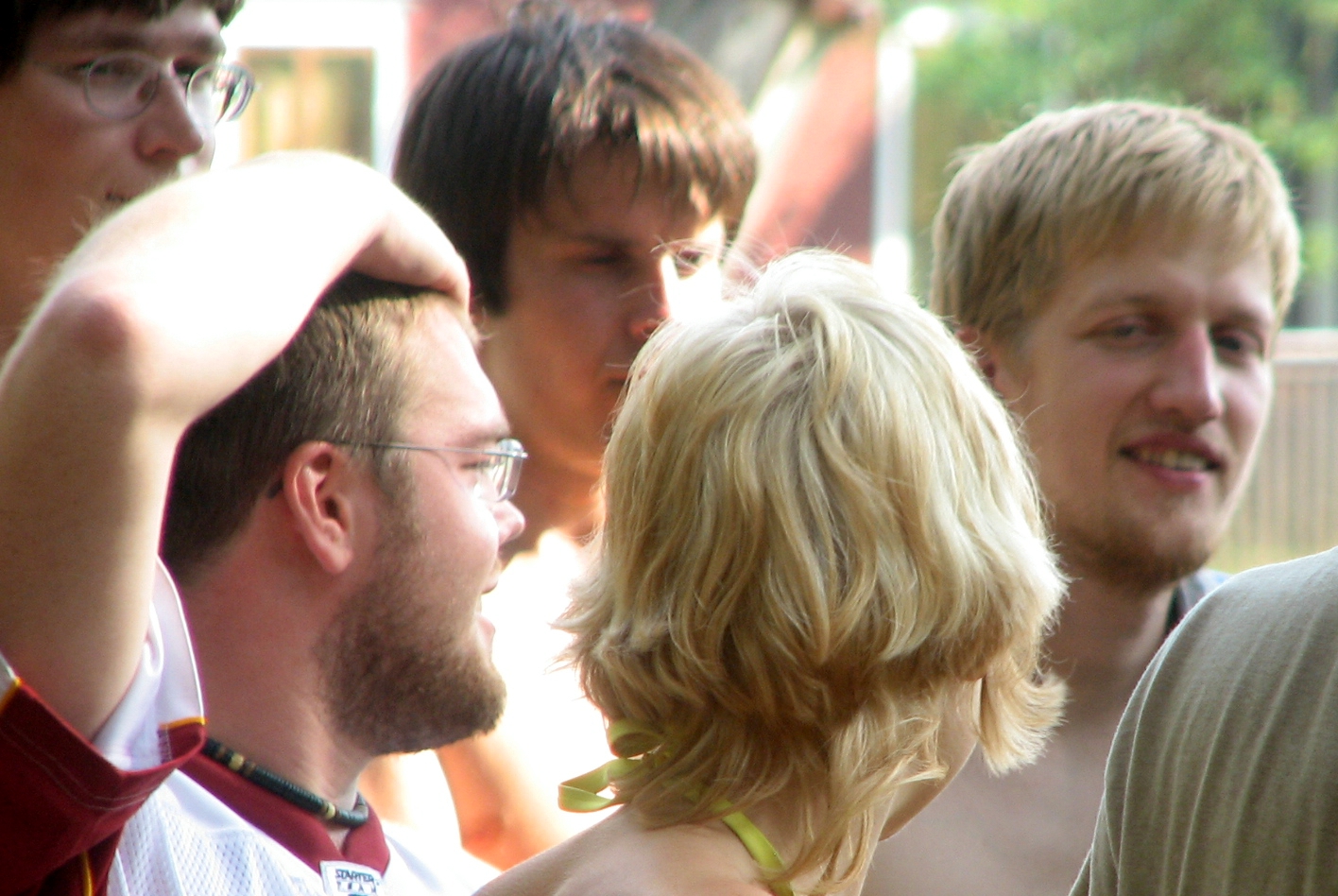 a group of men stand with each other looking at soing