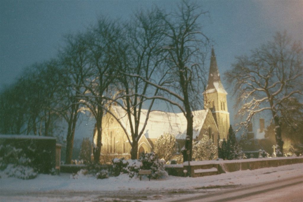 an old church in a city on a snowy day