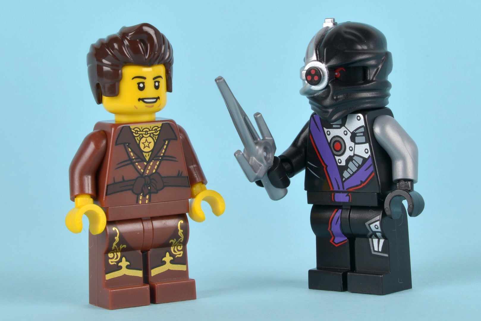 two lego figurines that appear to be holding scissors