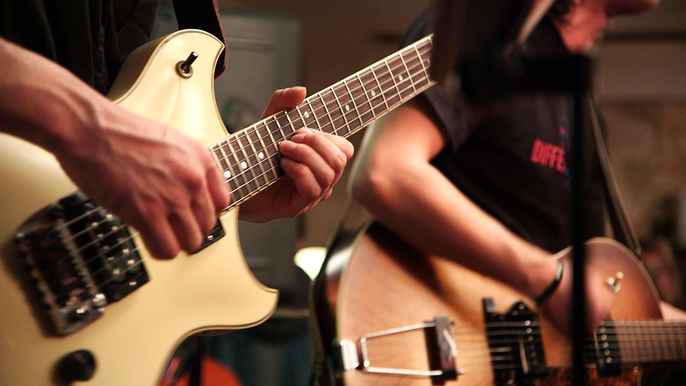 a couple of guys that are playing some guitars