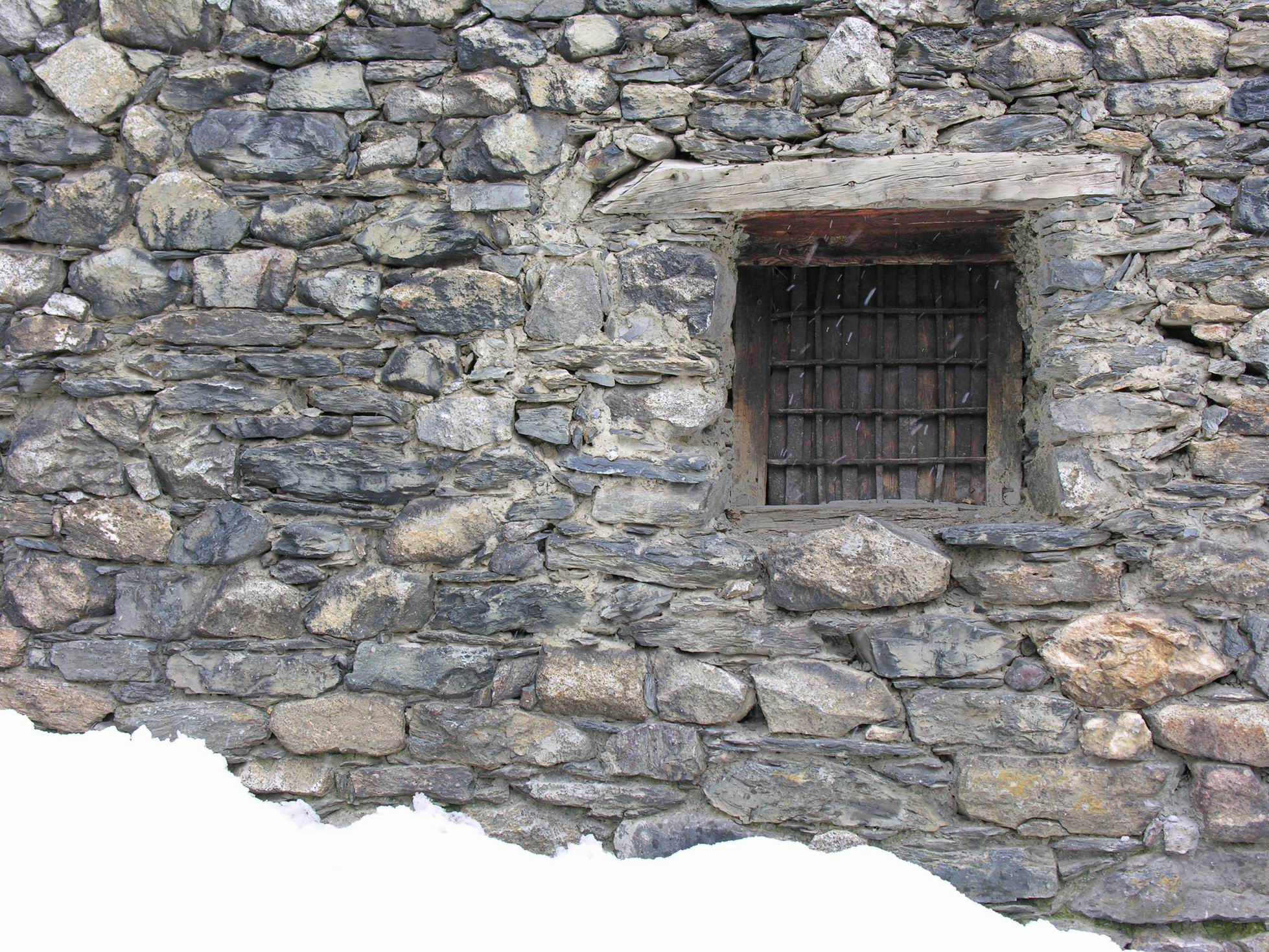a stone building with a window and stone steps