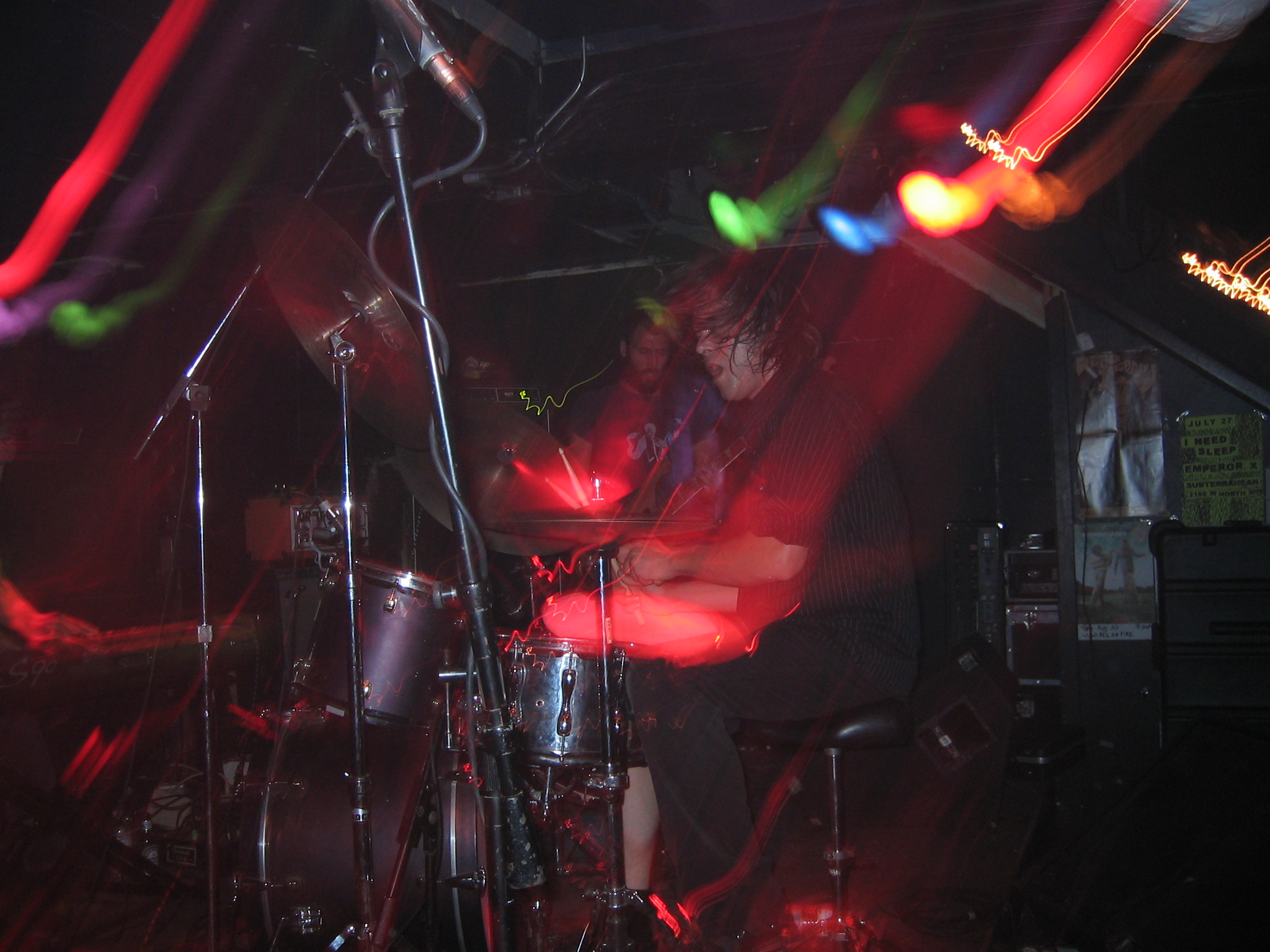 a drummer playing with a large drum set up