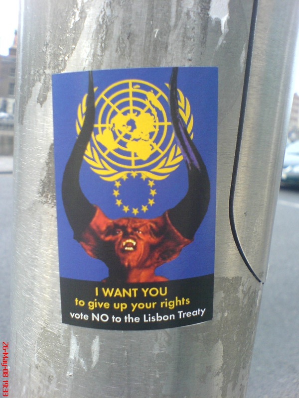 a sticker on the side of a pole with a political ad