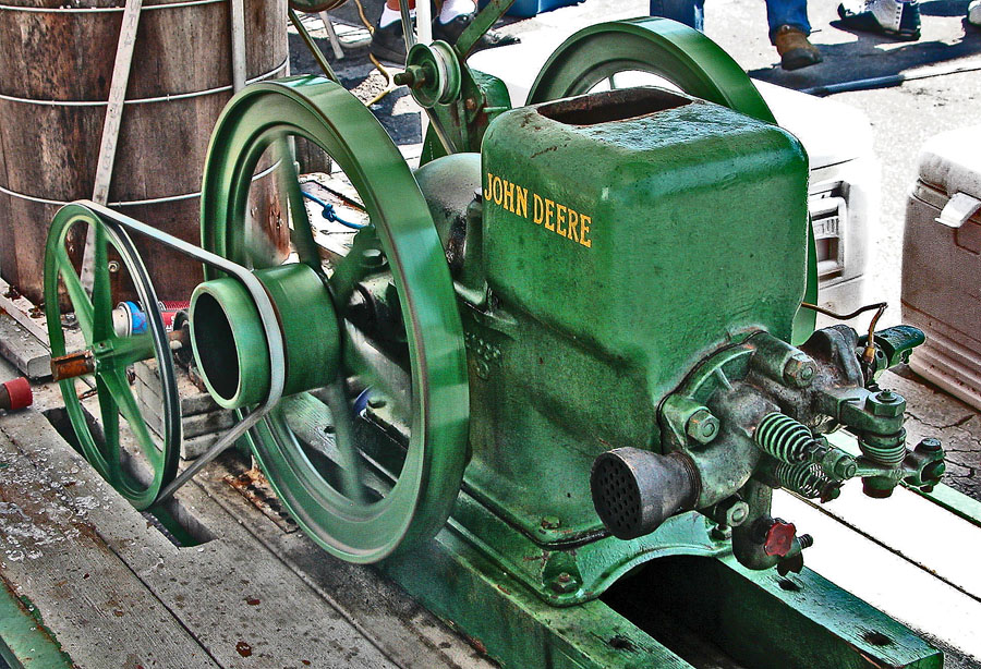 a green machine sits in front of some people