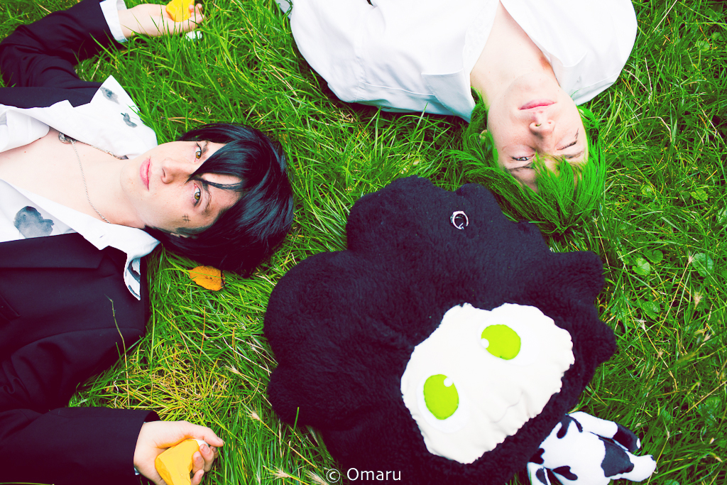 two women dressed up as characters laying in the grass