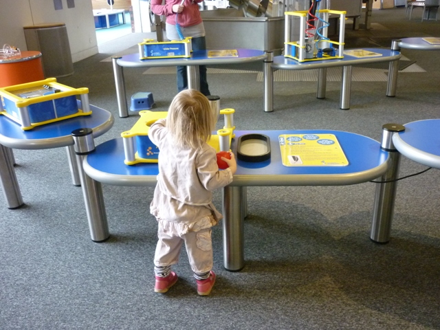 a child playing with toys at a play table