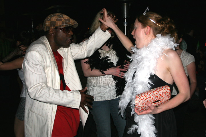 a man dancing with a woman dressed in costume