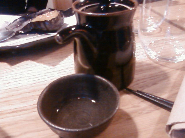 a coffee mug on a table with a spoon and knife